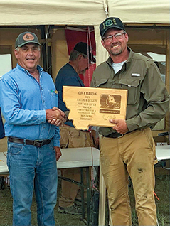 Dan Boenker (right) accepts his trophy for capturing first-place in this year’s Quigley Match.